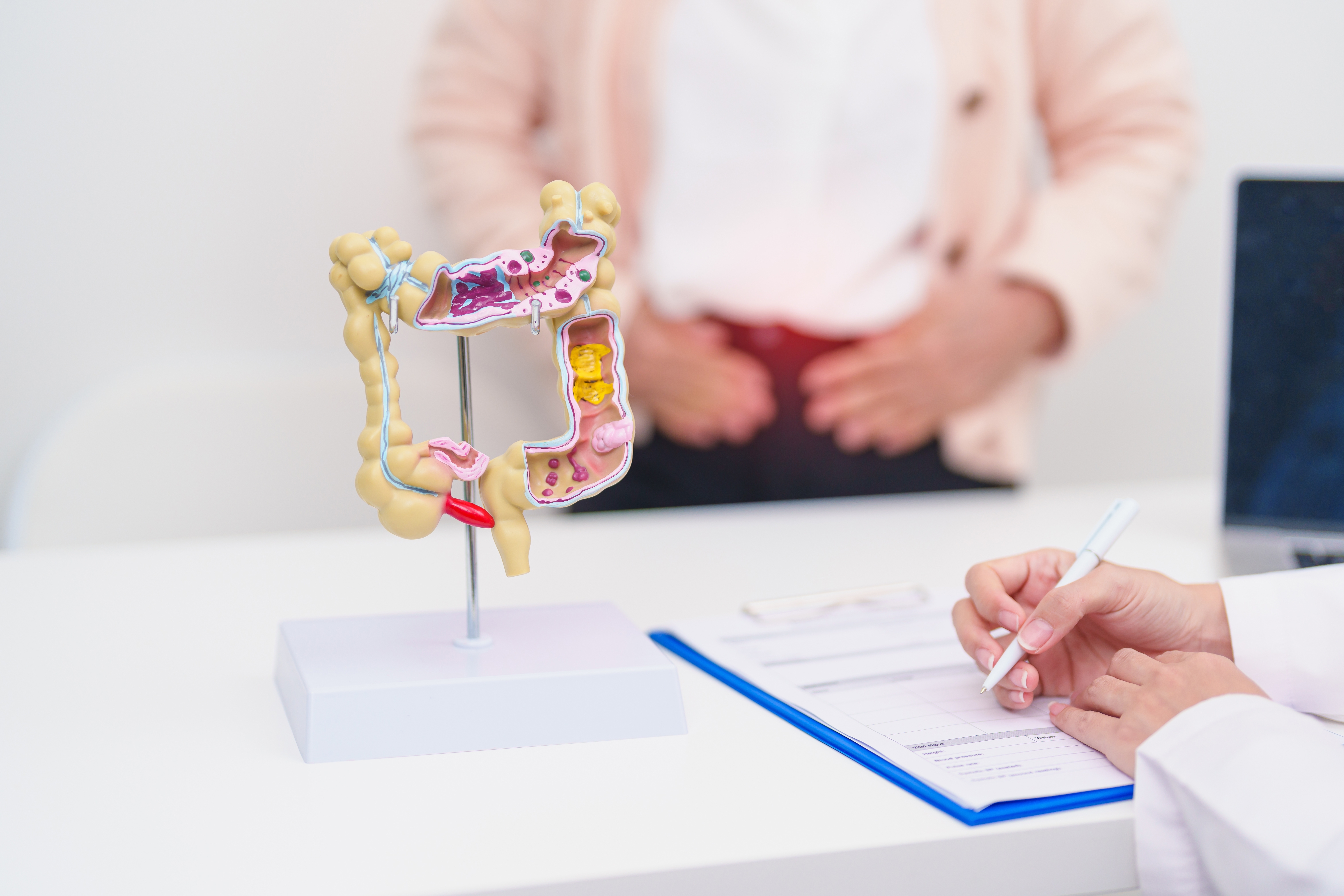Female patient consulting a physician about colon concerns in a medical office