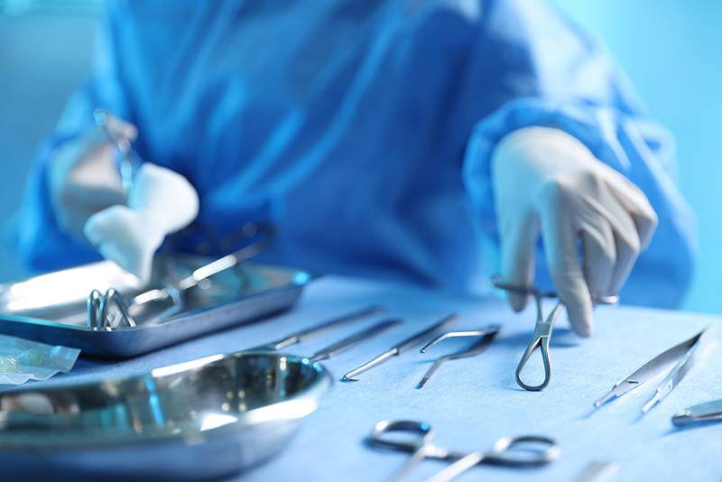 Doctor with surgical instruments on a table